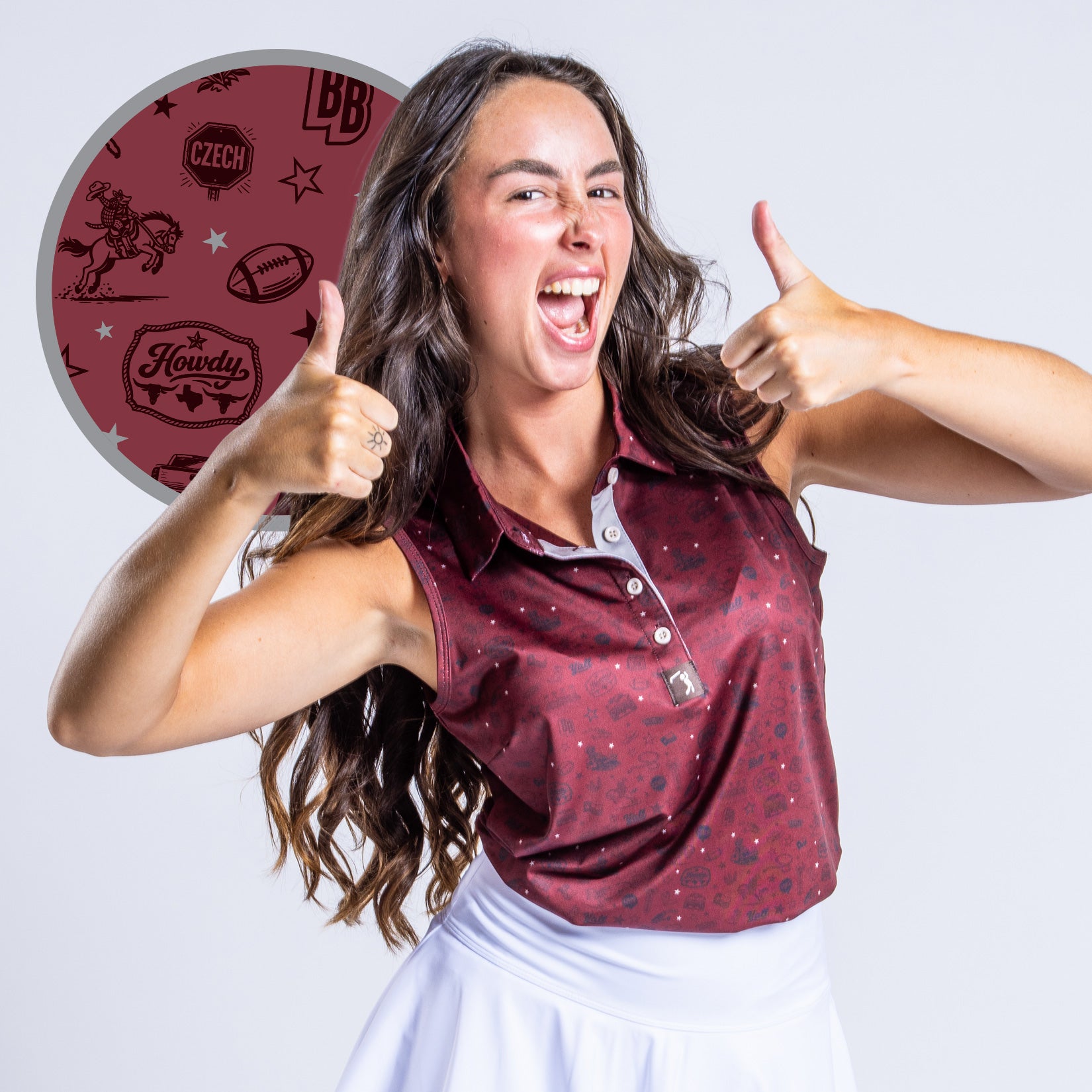 A smiling woman with long dark hair gives two thumbs up. She wears a maroon sleeveless polo with a subtle pattern and a white skirt. An inset shows the shirt detail: footballs, Howdy, Czech, a cowboy, Texas, and other maroon-themed graphics.