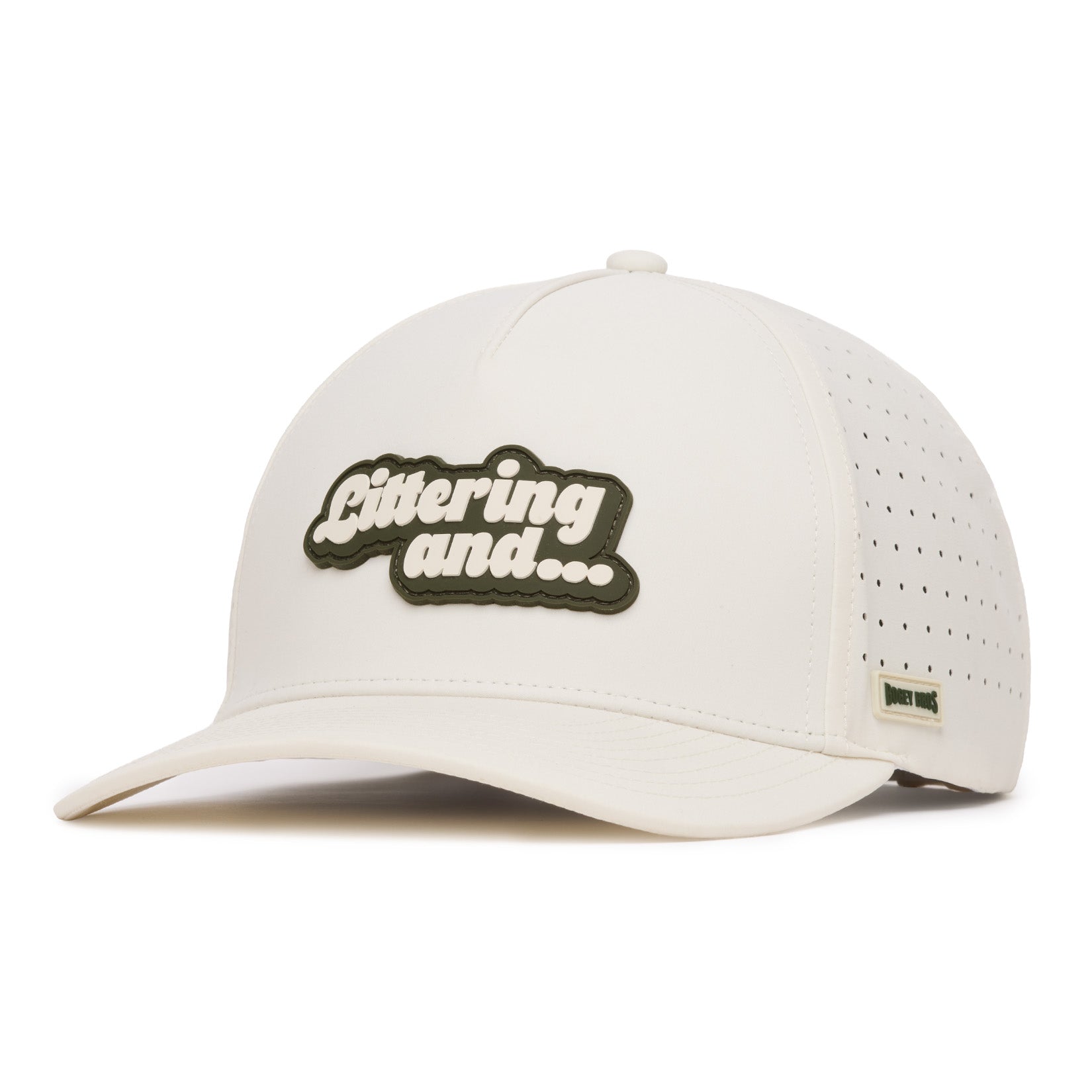 A white baseball cap with a curved bill features the phrase Littering and... in raised, white letters on a green patch. The sides have small perforations. A small rectangular tag with unreadable text is sewn near the brim on the right side.