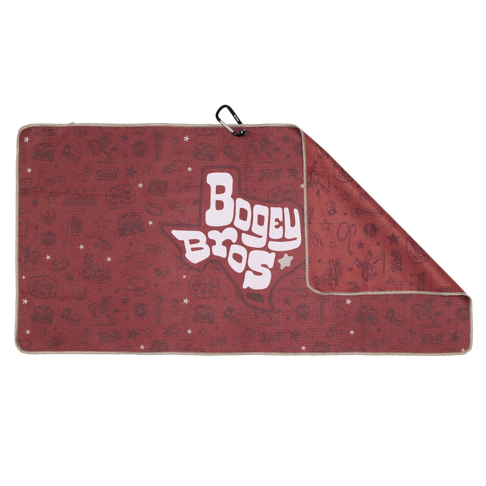 A maroon towel with playful, light icons and the words “Bogey Bros” in white inside a Texas-shaped outline; the top right corner is folded, revealing the underside, and a black carabiner is attached on the upper edge.