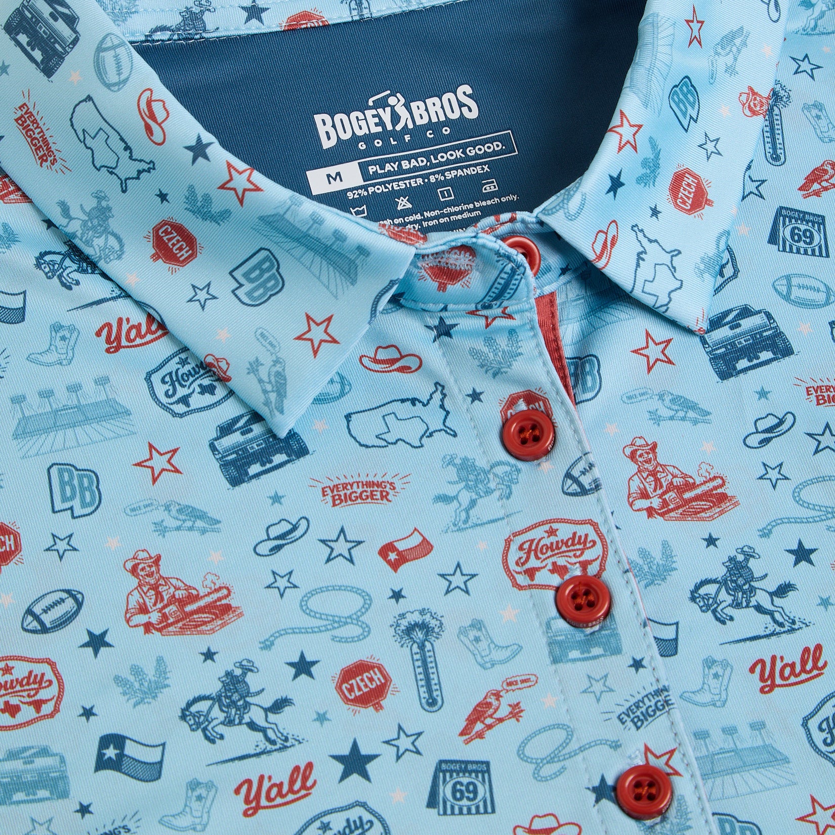 A light blue collared shirt with red and blue Western-themed illustrations, including cowboy hats, boots, guitars, cacti, stars, and phrases like Howdy and Yall. Red buttons and a Bogey Bros brand label are visible inside the collar.