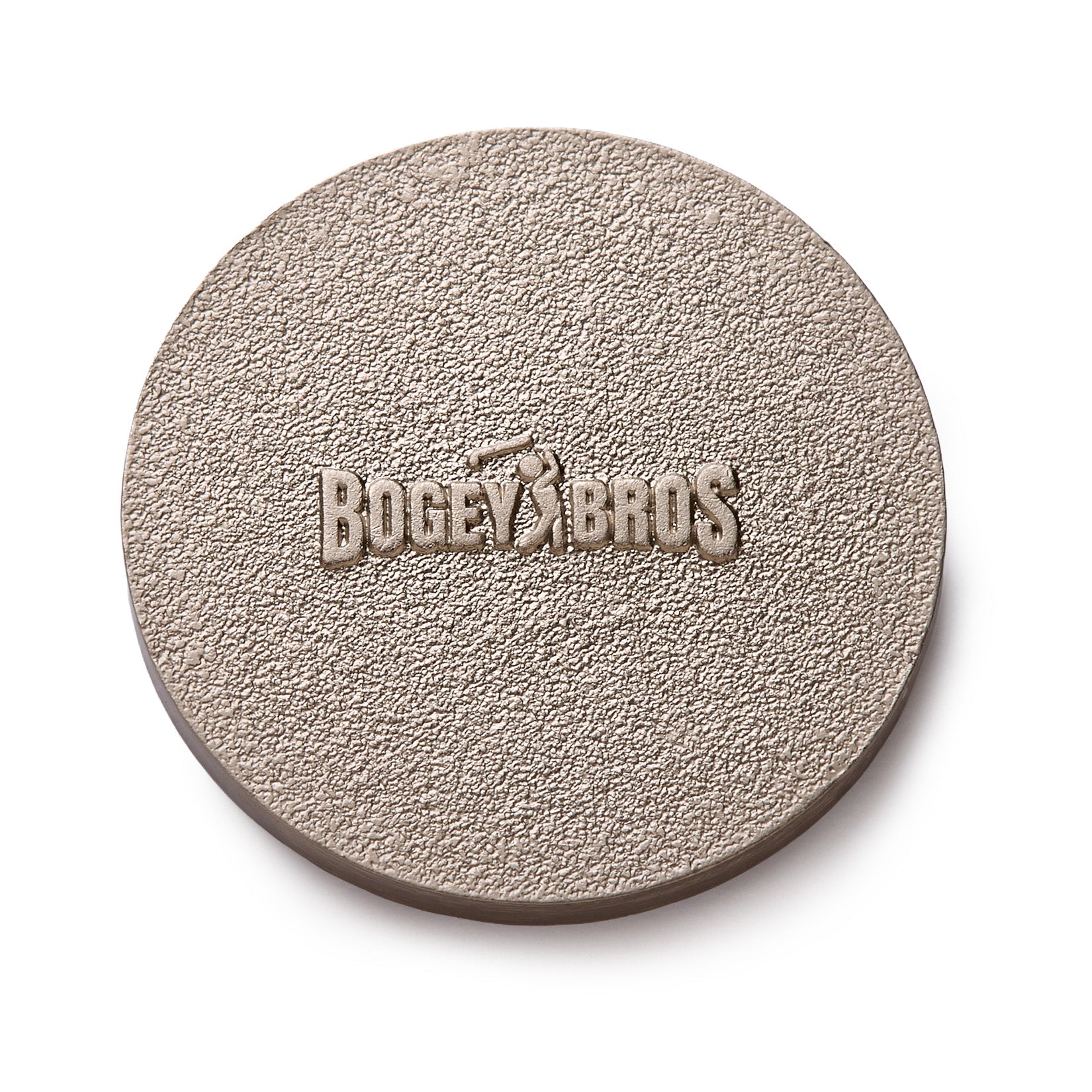 A round, textured, light brown object with the words BOGEY BROS and the silhouette of a golfer embossed in the center. The surface appears rough and grainy.