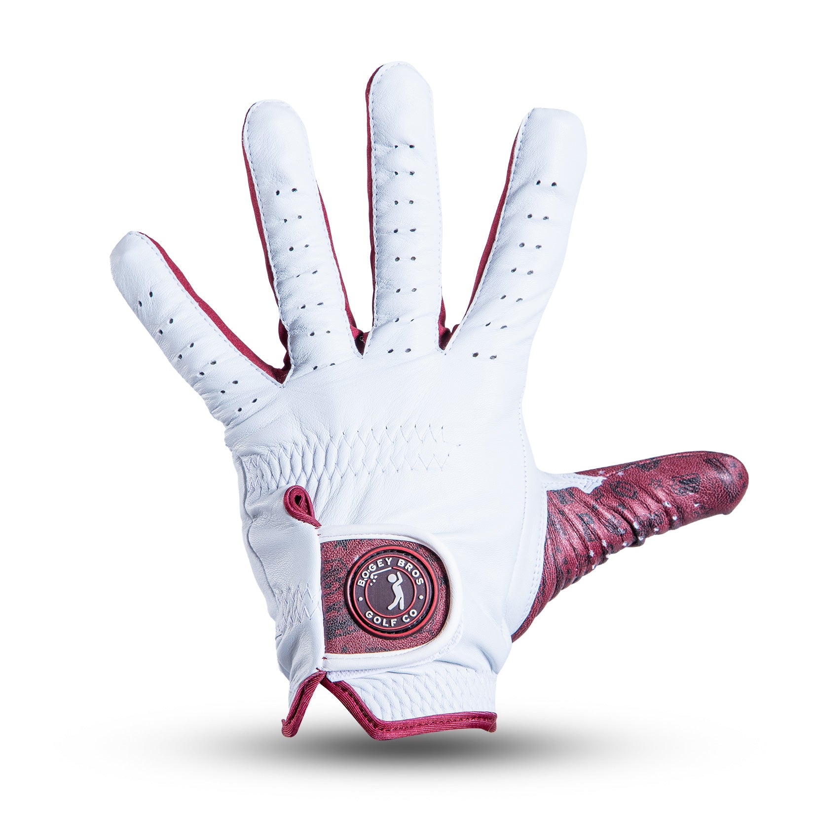 A white golf glove with red trim and perforated fingers is shown palm up. It features a circular logo patch near the wrist with a golfer silhouette and text. The thumb has a red textured design. The background is plain white.