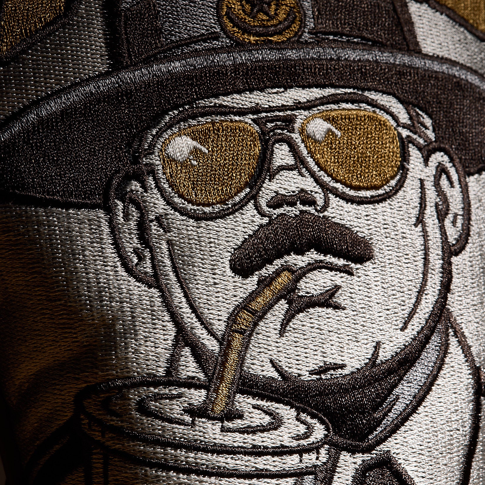Introducing the Liter-O-Cola - Driver Headcover: Inspired by an embroidered patch featuring a uniformed figure with a mustache, hat, and reflective sunglasses sipping a drink through a straw. Showcasing gold, brown, and white tones for an authoritative yet playful look, this standout driver headcover brings bold character to your golf game.