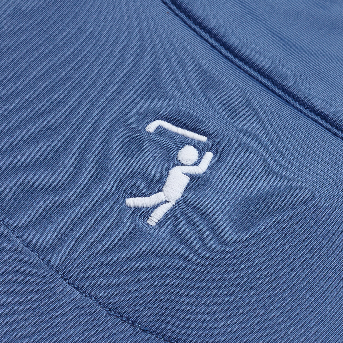Close-up of Cooler Blue - Q-Zip fabric showing a small, white embroidered figure swinging a golf club, with one arm raised and bent, legs apart, and dynamic motion details. The clean stitching stands out on the super stretchy material, which has visible seams and a smooth texture.