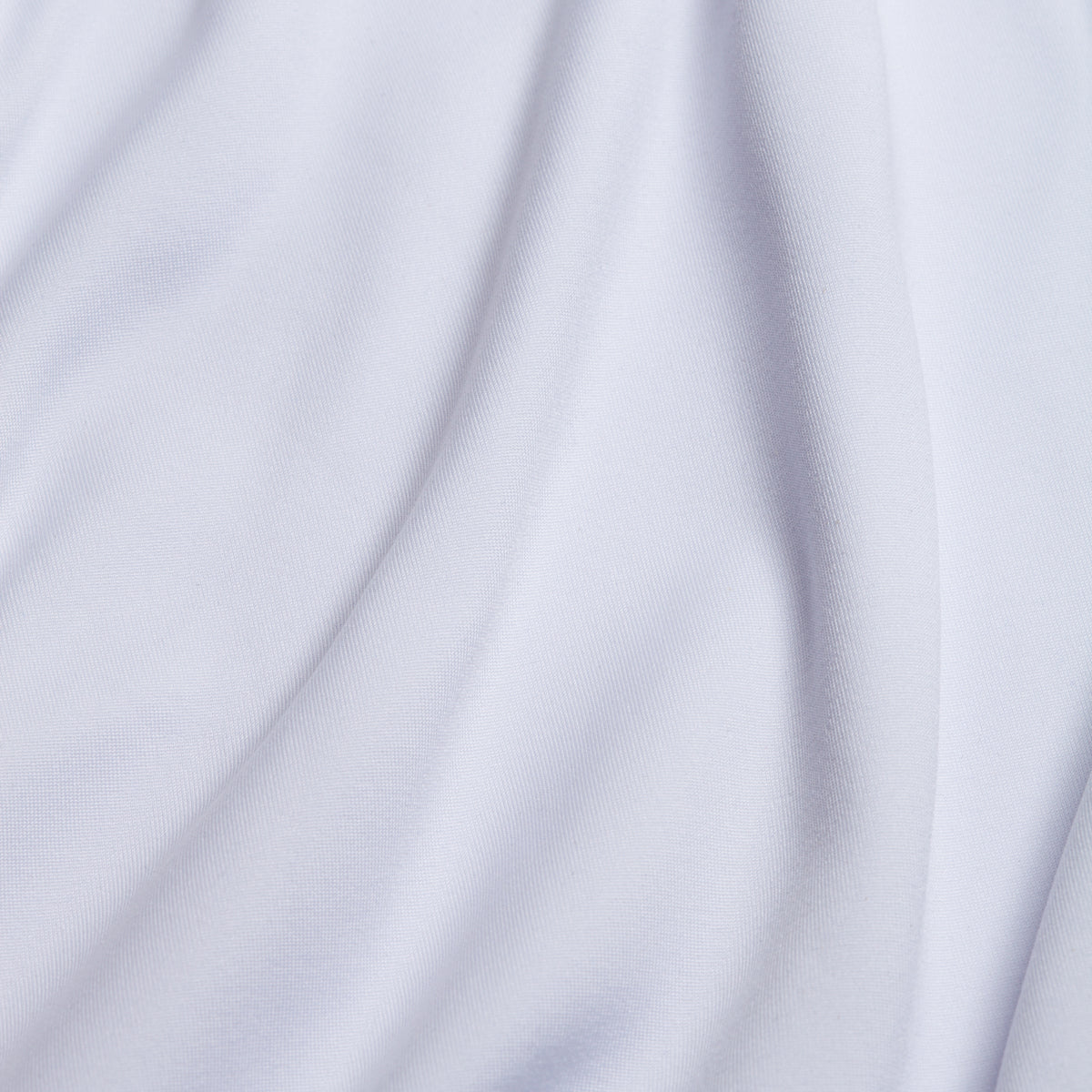 Close-up of the White - Hoodie’s smooth fabric with gentle, soft folds and subtle shadows running diagonally across the surface, giving it a fluid, draped appearance. Engineered with moisture-wicking properties, this hoodie ensures comfort while maintaining its elegant look.