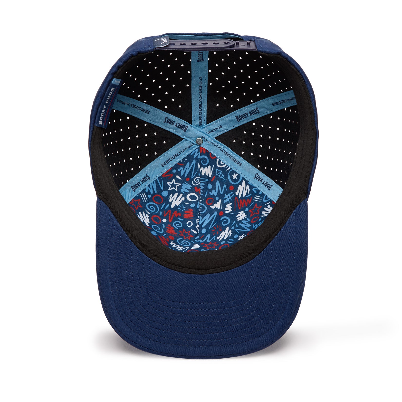 A blue baseball cap viewed from below, showing the inside. The crown features a blue lining with playful red, white, and blue doodles and shapes. Pale blue cross straps with text and white perforations are visible inside the cap. The brim is solid blue.