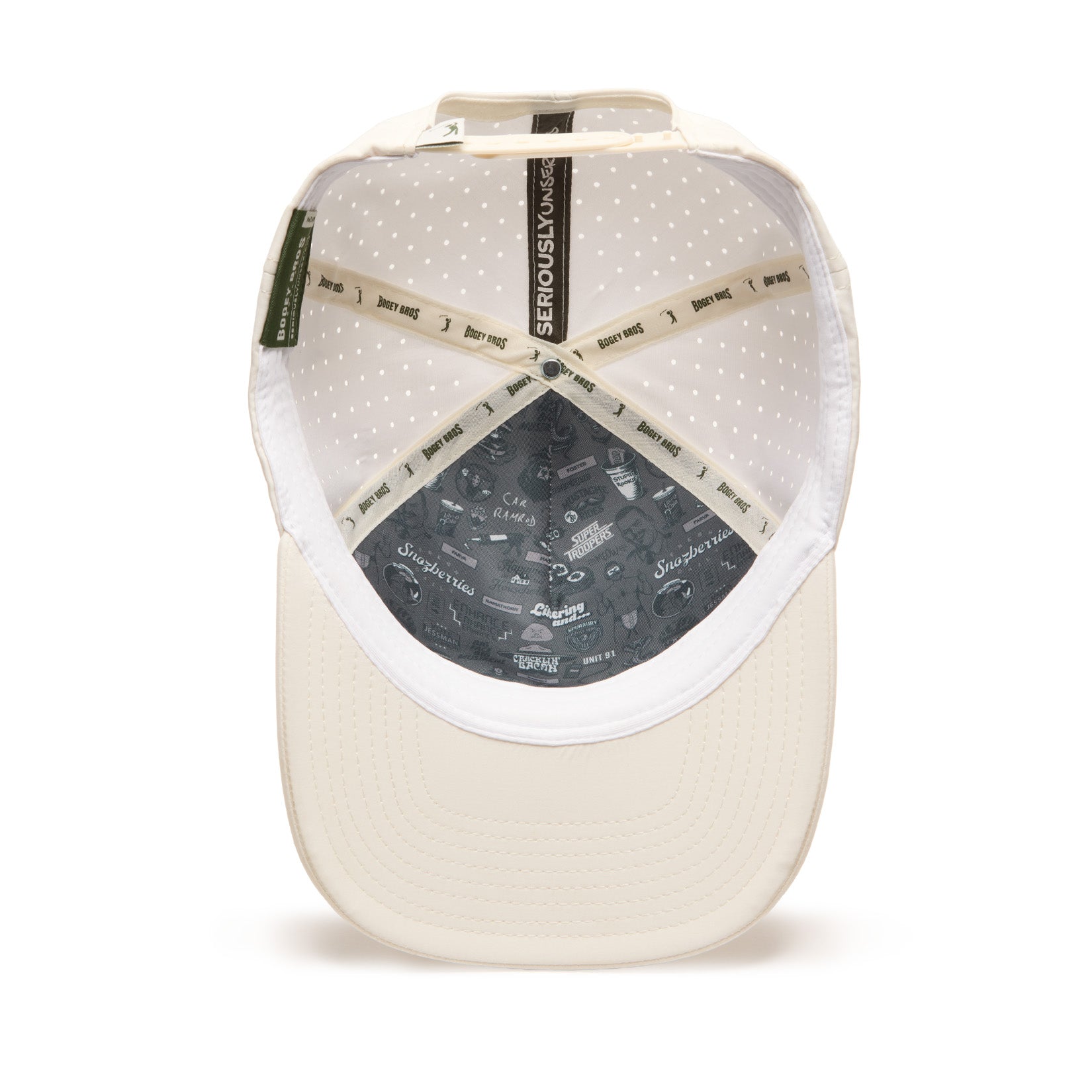 Beige baseball cap shown from underneath, revealing a white mesh interior with small dots, beige stitched bands reading SERIOUSLY KIND, and dark gray lining at the crown decorated with small graphics and playful text.