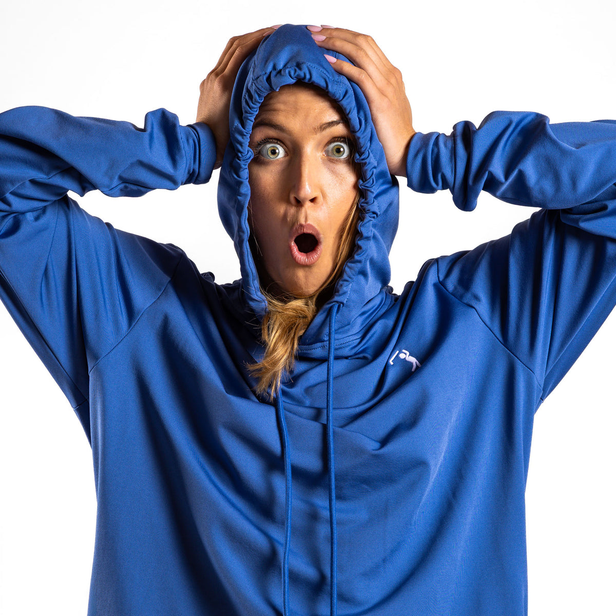 A person wearing the Cooler Blue - Hoodie with the hood up and super stretchy athletic shorts stands against a plain white background, holding their head with both hands and looking shocked, eyes wide open and mouth in an O shape.