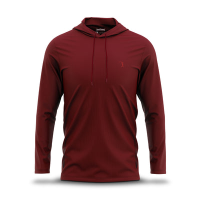Introducing the Burgundy - Hoodie by Bogey Bros: a long-sleeve, dark red hooded shirt crafted from lightweight performance fabric with subtle vertical texture and UPF 50 protection. It features a matching drawstring hood and a small, tonal embroidered golf logo on the left chest. The shirt is displayed against a plain white background with a subtle shadow.