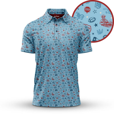 Light blue short-sleeve polo shirt with small red and blue icons, including footballs, stars, leaves, and cartoon figures. The zoom inset highlights the pattern details clearly on the shirt’s fabric.