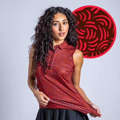 A woman with long curly hair models the Arcs - Red - Women's Polo, a sleeveless red collared shirt with a black and red swirling pattern and athletic fit. She displays the shirt against a gray background with a close-up of the design behind her.