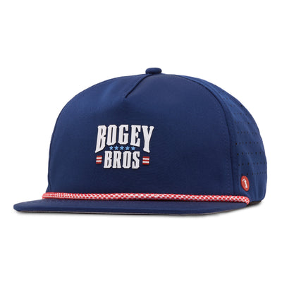 A blue snapback hat with BOGEY BROS in white, bold letters on the front, accented by red and white stars and stripes. The cap has a flat brim with a red and white patterned rope detail and small ventilation holes on the side.