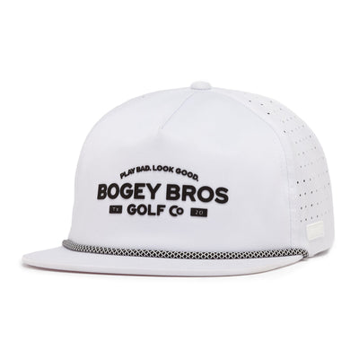 The TX20 Unstructured Flat Bill Hat is a white performance snapback with perforated sides and a black-and-white rope. Bold black "BOGEY BROS GOLF CO" and "PLAY BAD. LOOK GOOD." are displayed on the front.