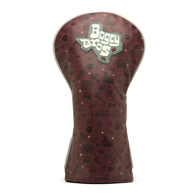 The Hard Corps - Driver Headcover is crafted from premium maroon PU leather and showcases an embroidered Texas outline with Bogey Bros text, complemented by small black golf and Texas-themed icons scattered across its smooth surface. Standing upright on a white background, this headcover combines style and durability to elevate your golf gear.