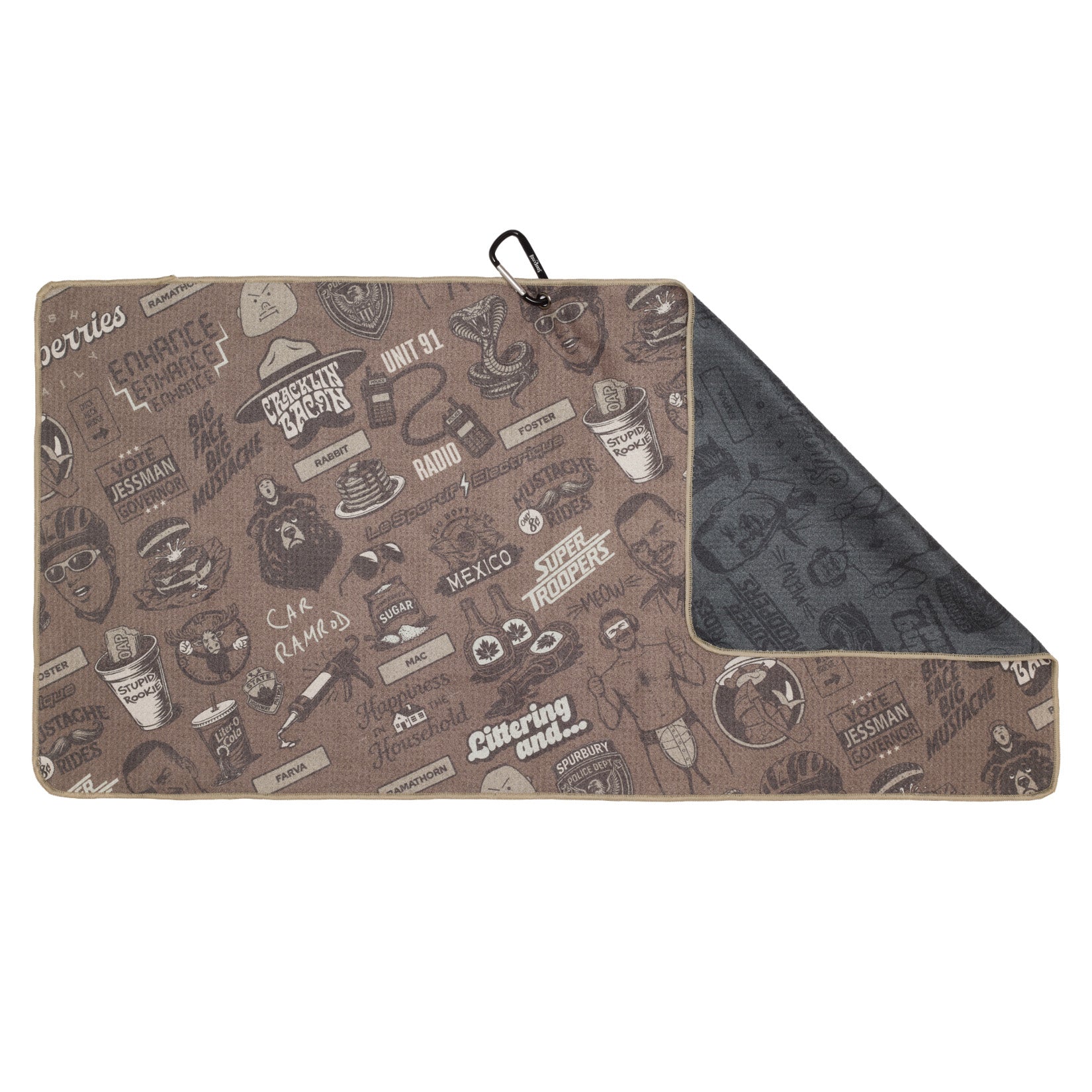A rectangular brown mat with black cartoon-style sketches and text, including objects, animals, faces, and phrases. The top right corner is folded to reveal a dark gray underside. A black clip is attached to one edge.