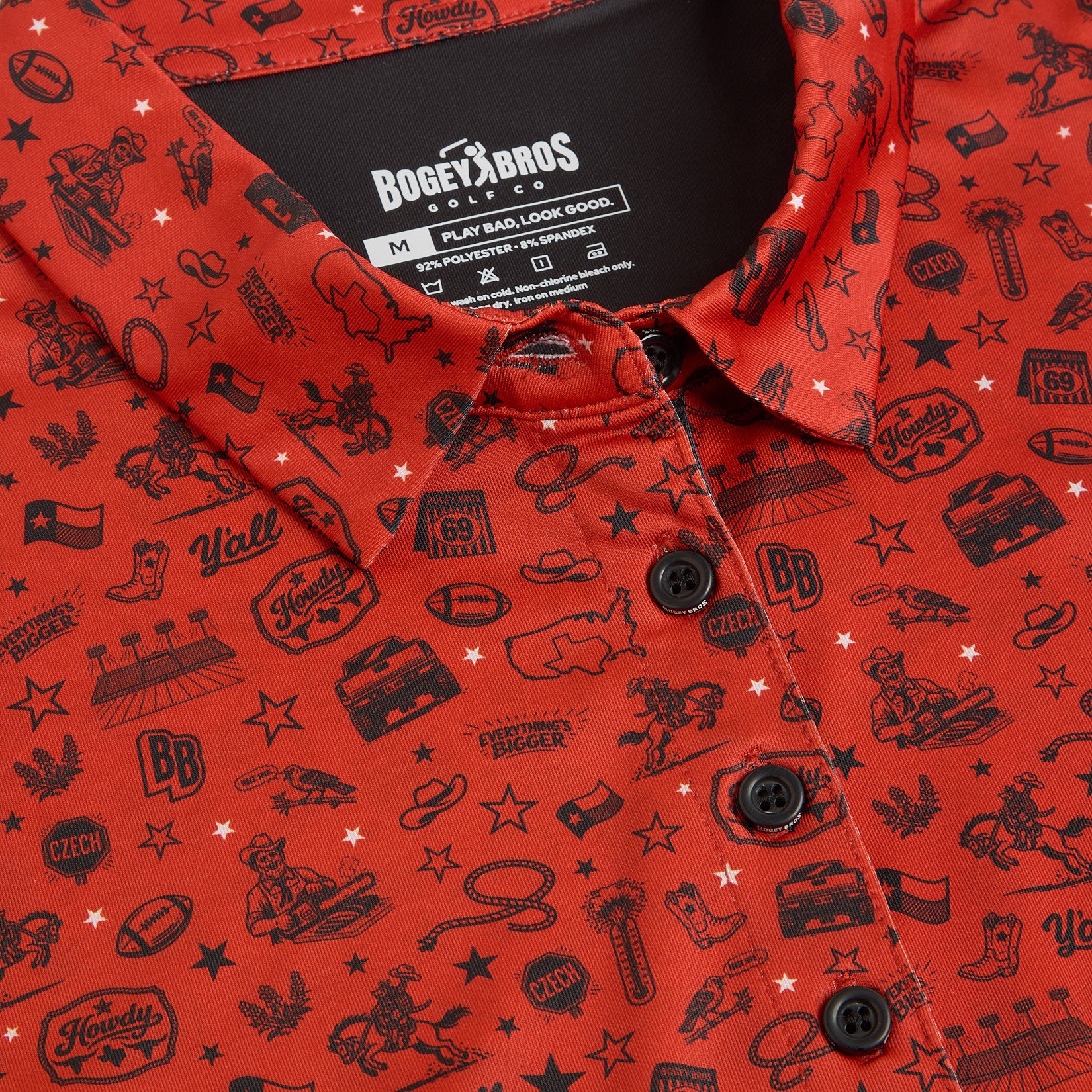 A red button-up shirt with black western-themed illustrations, including cowboy hats, boots, stars, trucks, cacti, guitars, the words Howdy and Yall, and various Texas icons. The collar and black label are visible at the top.