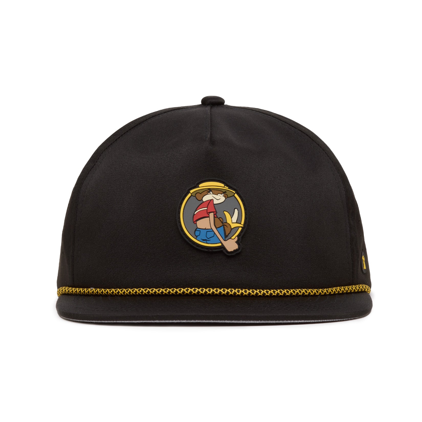 A black hat with gold trim at the brim features a cartoon character patch on the front, showing a smiling person in a hat holding up three fingers. The hats material appears smooth, and its shape is rounded without a visible brim.