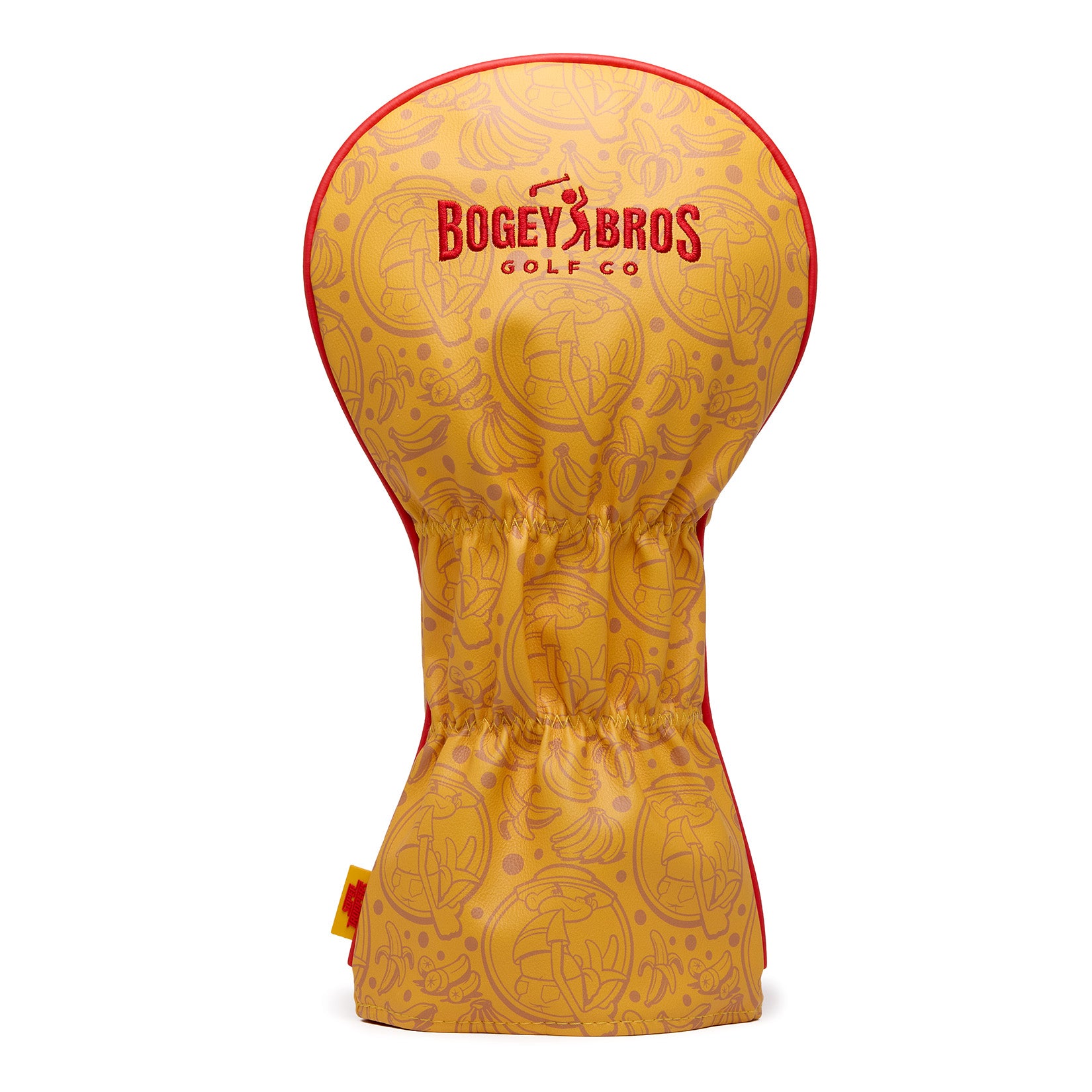 Introducing the Johnny Chimpo - Driver Headcover: a premium yellow PU leather driver cover featuring playful cartoon embroidery, bold red “Bogey Bros Golf Co” text, and eye-catching red edging. This stylish headcover is cinched at the middle for a secure fit and stands upright against a white background. Durable with its woven label design, it’s the perfect accessory for any golfer looking to add character and protection to their gear.
