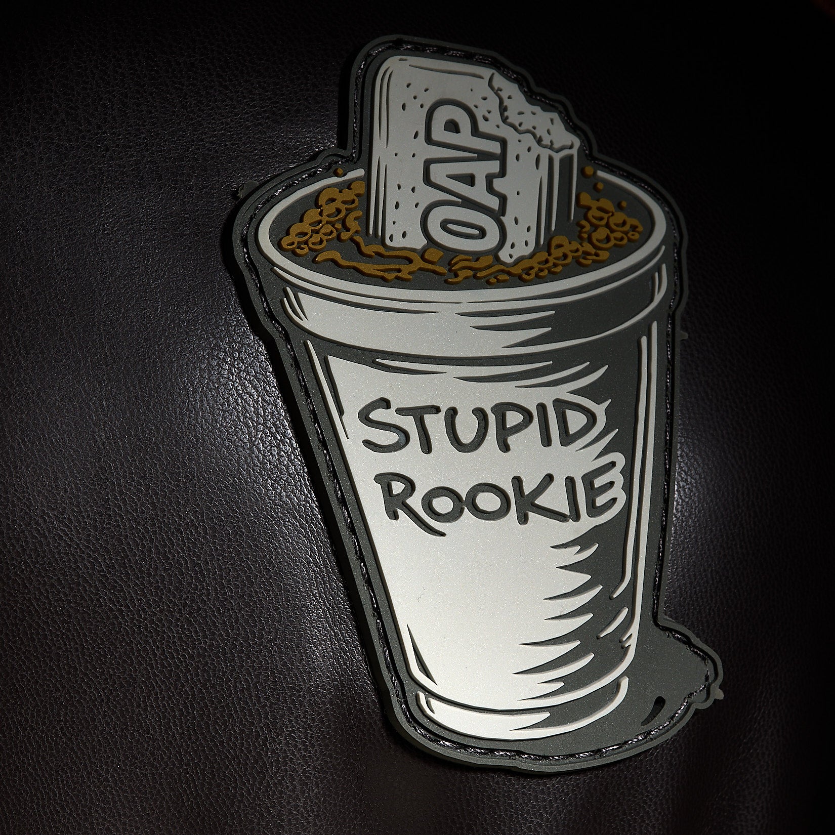 Introducing the Liter-O-Cola - Driver Headcover featuring an embroidered trash can overflowing with brown waste, a broken “OAP” tombstone, and bold “STUPID ROOKIE” text on premium textured dark PU leather.