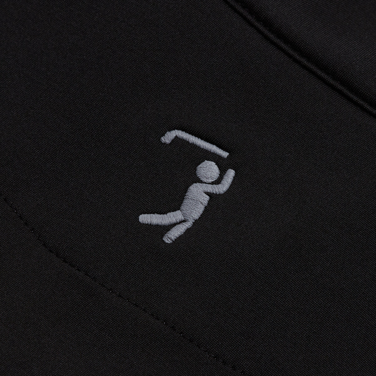 A gray, minimalist embroidered figure swings a hockey stick over its head on the solid black fabric of the Black - Q-Zip, creating a playful sports motif. Smooth stitching stands out against the background, while its athletic fit and moisture-wicking properties ensure comfort and style for active enthusiasts.