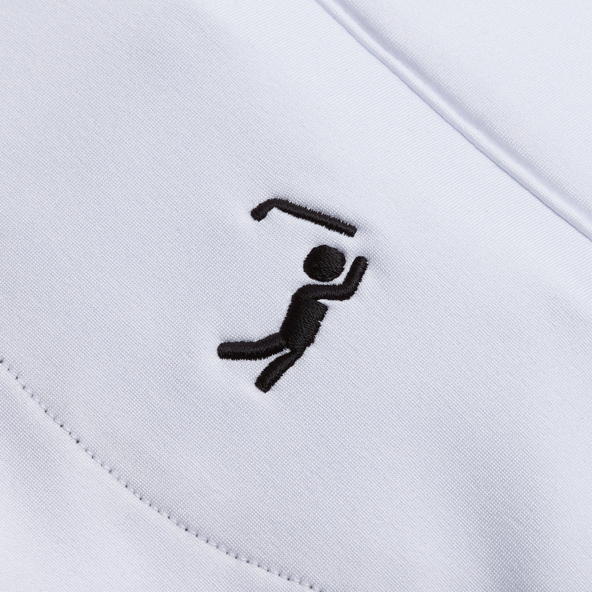 A black embroidered stick figure swings a golf club over its head on the White - Q-Zip. Crisp, clean stitching highlights the action across smooth white fabric that provides UPF 50 protection. The embroidery is positioned diagonally for an athletic fit look.