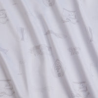 The Country Club - Polo features white fabric with a light gray vintage pattern of shoes, mustaches, suits, top hats, and frames. This smooth material offers UPF 50 protection and a classic, elegant style with a soft drape.