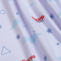 A close-up of the Curves Right - Polo shows white, athletic fit fabric with light blue snowflakes, geometric shapes, and red “Curves Right” text. Gentle folds create soft highlights and shadows on this playful, winter-themed material.
