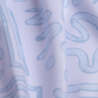 Close-up of the Dipsy Doodle - Polo’s light, moisture-wicking fabric in pale blue. Subtle abstract wavy lines and loops stand out on a white background, with vertical folds adding soft shadows and texture.