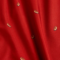 A close-up of the Doggy Dog - Polo shows its vibrant red, moisture-wicking fabric with a subtle wavy texture and small, embroidered hot dog motifs—each complete with bun, sausage, and mustard—for comfort and playful style.
