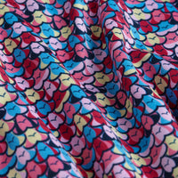 The Eyes Up Here - Shagadelic - Polo features a vibrant, super stretchy fabric with a bold repeating pattern in red, blue, yellow, pink, and black. Slight folds enhance texture for playful style and all-day comfort.