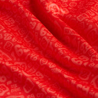 A close-up of the Going Low - Polo's bright red, wavy-textured fabric with subtle light red and pink numerals and geometric shapes. The soft, slightly translucent material features moisture-wicking properties for active comfort.