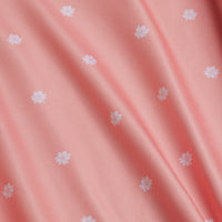 The In Bloom - Polo features a soft pink fabric with small white floral patterns and a smooth texture. Its moisture-wicking properties keep you comfortable and dry, while diagonal shadows enhance the depth of the design.