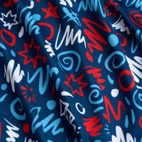 A close-up of blue fabric featuring a lively pattern of red, white, and light blue scribbles, swirls, zigzags, stars, and abstract shapes, creating a playful and energetic design. The material appears slightly wrinkled.
