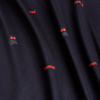 The Night Owl - Polo features dark, moisture-wicking fabric with a repeating pattern of red HOOTERS logos and stylized owl faces with red eyes and white outlines, keeping you cool, dry, and stylish. Fabric may appear slightly textured.