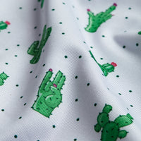 The Prick-Ly Pear - Polo features white fabric covered in green cartoon cacti, pink flowers, and tiny polka dots. Slight folds and textured lines create an athletic fit that's comfortable and moisture wicking.