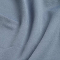 Close-up of Solid Carolina Blue - Polo fabric with fine, diagonal weave and gentle folds. Subtle sheen and moisture-wicking features make it ideal for activewear, ensuring maximum comfort and performance.