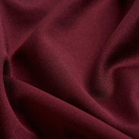 Close-up of the Solid Oxblood - Polo fabric, featuring a soft matte texture and fine weave. The gently draped material showcases rich oxblood color and moisture-wicking properties for comfortable, dry wear.