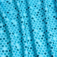 A close-up of Dots - Teal - Polo shows light teal fabric with a repeating pattern of small, dark teal ovals. The athletic fit material drapes softly in gentle folds, adding depth and shadow to the textured pattern.
