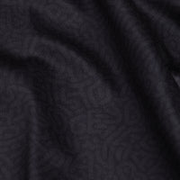 Close-up of the Stealth Mode - Dark - Polo’s ribbed fabric in deep charcoal gray, featuring soft, smooth texture, gentle folds with shadows and highlights, subtle vertical lines, and moisture wicking properties.