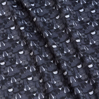 Close-up of the T&A - Fitty Shades - Polo, featuring rippled black fabric with a repeating abstract pattern in white, grey, and black. This athletic fit polo offers dynamic style and moisture wicking comfort.