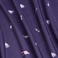 The Mixer - Polo features dark purple fabric with small sailboats, seagulls, and flags in pink, white, and blue prints. Gently gathered in soft vertical folds, this polo offers moisture wicking for comfort during active wear.