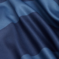 Close-up of smooth fabric on the Washed Up - Polo, featuring a blue checkered pattern, gentle folds, soft sheen, and fine vertical lines in the weave for a silky feel and moisture-wicking properties.