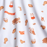 The Wingin' It - White - Polo is a white, moisture-wicking, UPF 50 shirt with a pattern of orange Hooters tank tops, shorts, chicken drumsticks, beer mugs, pretzels, cupcakes, and 