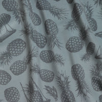 The Aloha Exchange - Women's Polo features gray fabric with a dark gray pineapple pattern in various orientations. Subtle folds and shadows add texture, and its athletic fit offers comfort and style for active wear.