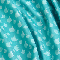 A close-up of the Birdie Finger - Women's Polo showcases teal, moisture-wicking fabric with a pattern of small white hand icons giving the middle finger, highlighted by subtle folds and shadows for added playful, rebellious flair.