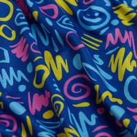 The Booyah Women's Polo features soft blue fabric with a colorful abstract 1980s-inspired pattern in yellow, pink, and turquoise. With UPF 50 protection, it blends playful style and sun safety for vibrant comfort.