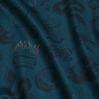 The Deep Trouble - Women's Polo features teal fabric with black sketches—snakes, mushrooms, a lobster—and BODEY BROS text. It offers an athletic fit, moisture-wicking comfort, and a lightly wrinkled look.