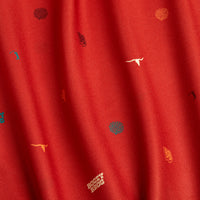 The Desert - Women's Polo features red fabric with colorful embroidered cacti, cowboy hats, steer heads, and Rocky Bros text on a slightly wrinkled surface. Enjoy UPF 50 protection for all-day outdoor comfort.