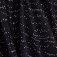 A close-up of the Easy Game - Women's Polo shows black fabric with white physics and math equations. The athletic fit features visible folds and provides moisture-wicking comfort for all-day wear.