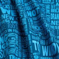 The Excuses - Women's Polo features blue, moisture-wicking fabric with bold white overlapping text in various fonts and sizes, including phrases like “TOO WINDY,” “PLAYED WITH NEW CLUBS,” and “TOO HOT.” The fabric has a slightly wrinkled look.